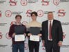 Smithtown High School East seniors Dylan McCormick and Matthew Pickow (left) were selected for the National School Development Council Award. They are pictured with Smithtown High School East Principal Dr. Kevin Simmons (far right).