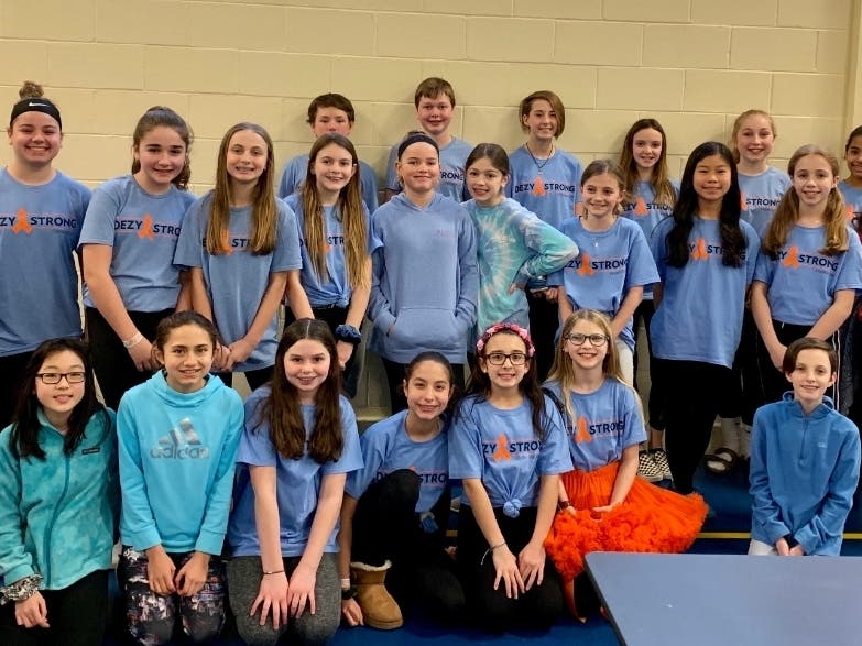 Port Jefferson Middle School students stood in unity in their DezyStrong T-shirts while having PJ Madness, a basketball tournament.