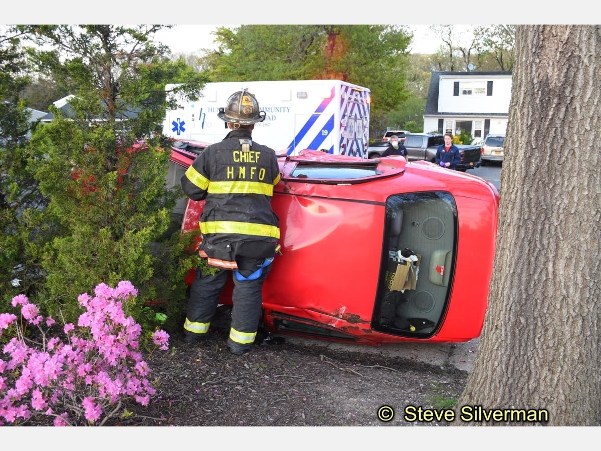 A car overturned behind Walt Whitman Shops in Huntington Station Saturday evening, prompting a response by the Huntington Manor Fire Department, Huntington Community First Aid Squad and Suffolk police.