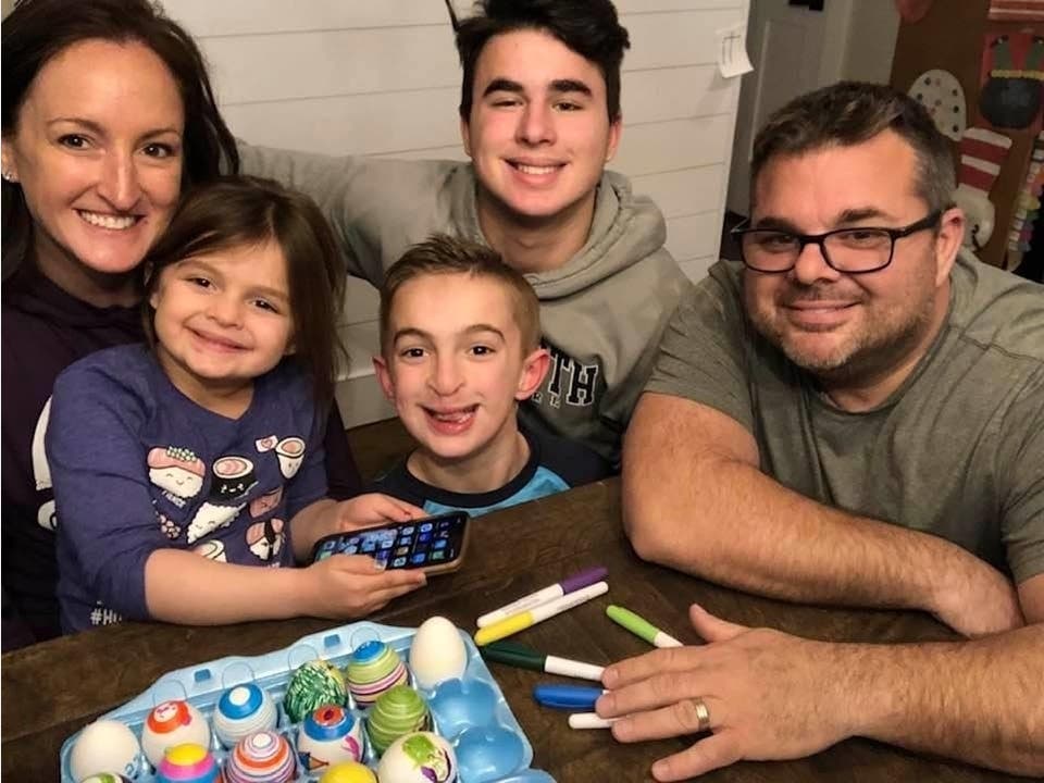 Carly Colvell (left), who's battling amyotrophic lateral sclerosis, also known as Lou Gehrig's disease, takes a photo with her family. The Farmingdale mom is trying to spread awareness of the disease through a social media challenge involving hair cuts.