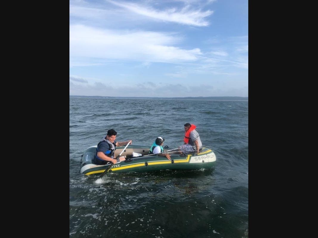 Three men were rescued from a raft on the Long Island Sound Sunday evening by Suffolk County Police Marine Bureau officers.