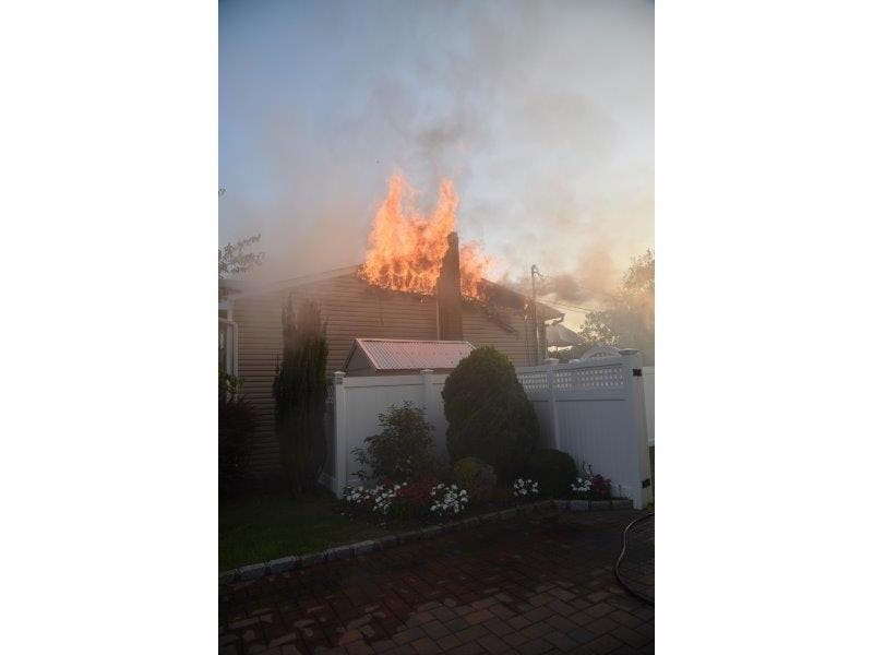 A Bethpage home caught fire Sunday evening after flames extended to the house from a BBQ.