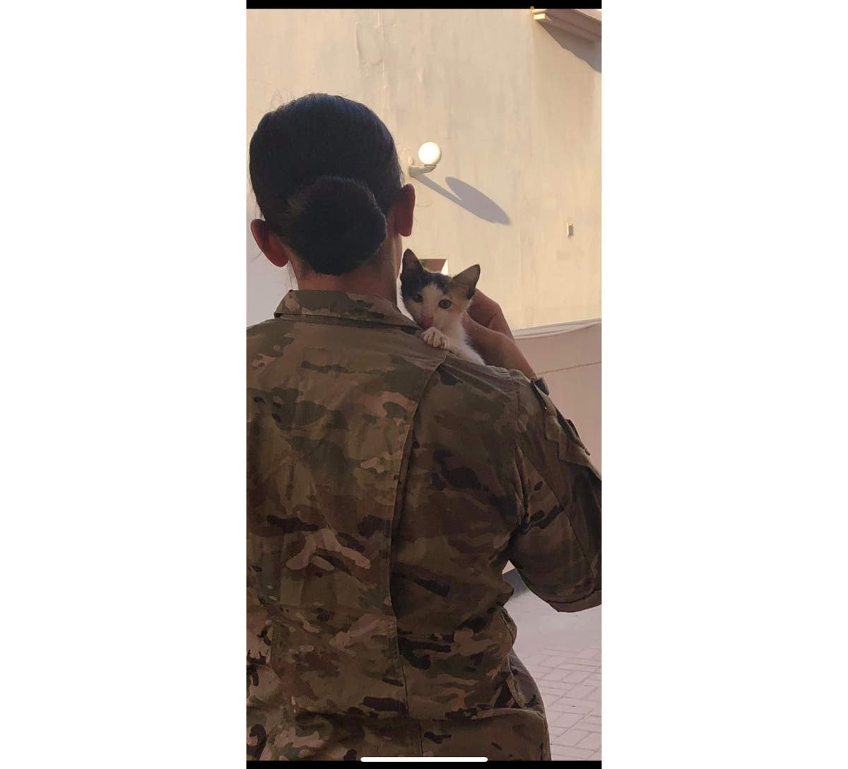 Army Sergeant Ash holds the cat she hopes to bring home from the Middle East to the United States with her. She turned to Smithtown-based Guardians of Rescue for help.