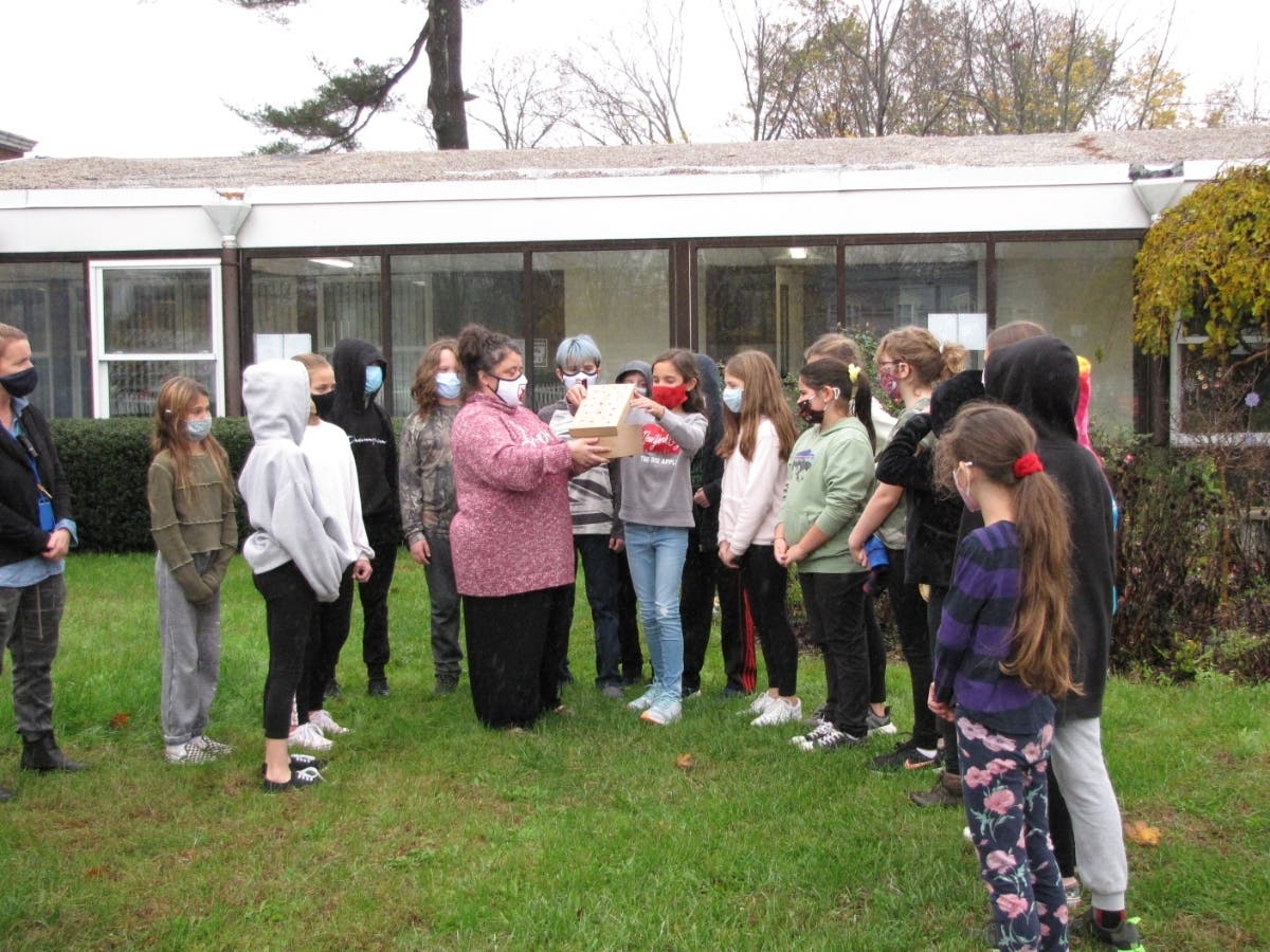 Students of Saint James Elementary School release a healed-up junco back into the wild.