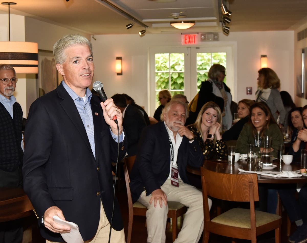 Suffolk County Executive Steve Bellone (holding microphone) called for the impeachment or removal of President Donald Trump in a statement on Thursday.