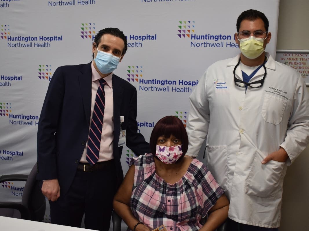 Alisa White, 61, of Wyandanch, is flanked by her doctors at Huntington Hospital. White defeated both pancreatitis and COVID-19.