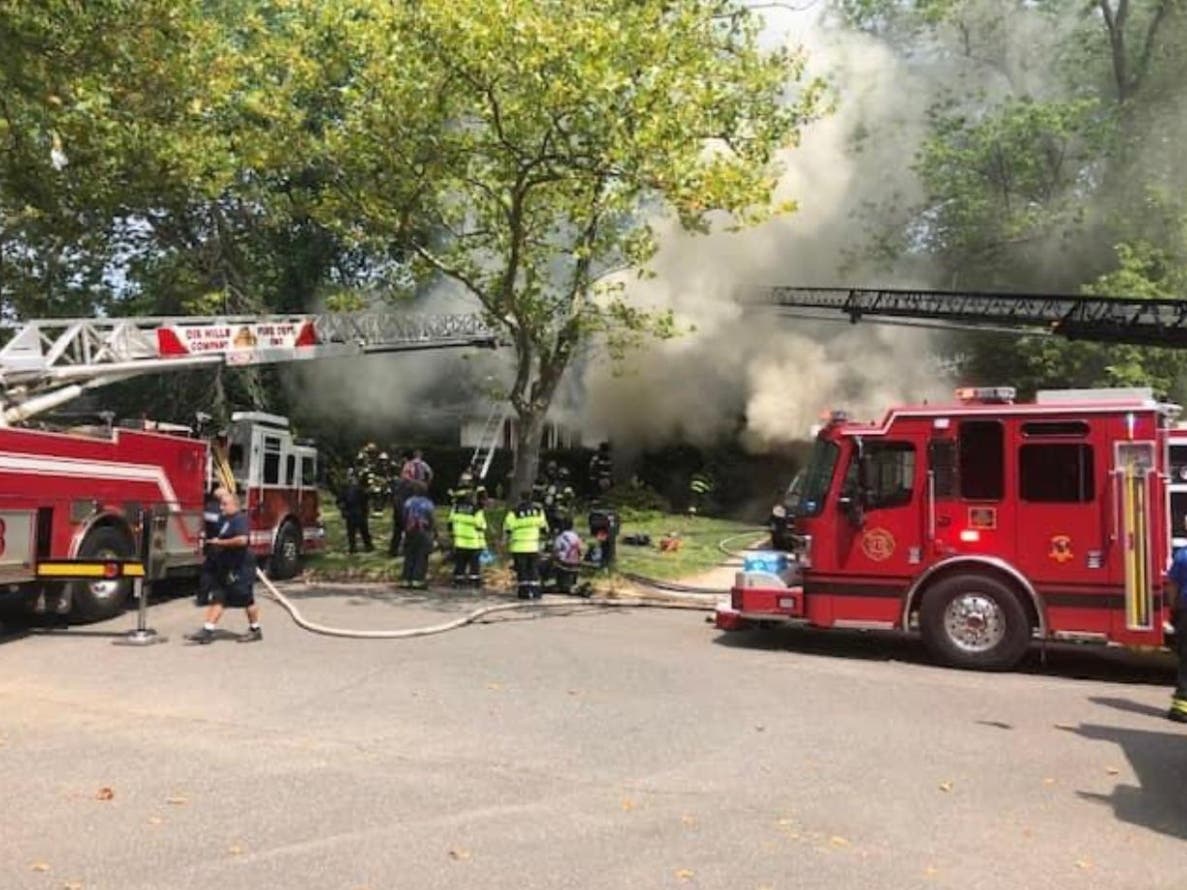 Firefighters from Greenlawn and more than a dozen other departments battle a house fire in Greenlawn on Monday.