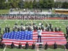A giant American flag was held aloft as the Harborfields High School Marching
Band played “The Star-Spangled Banner” to kick off the homecoming football game.