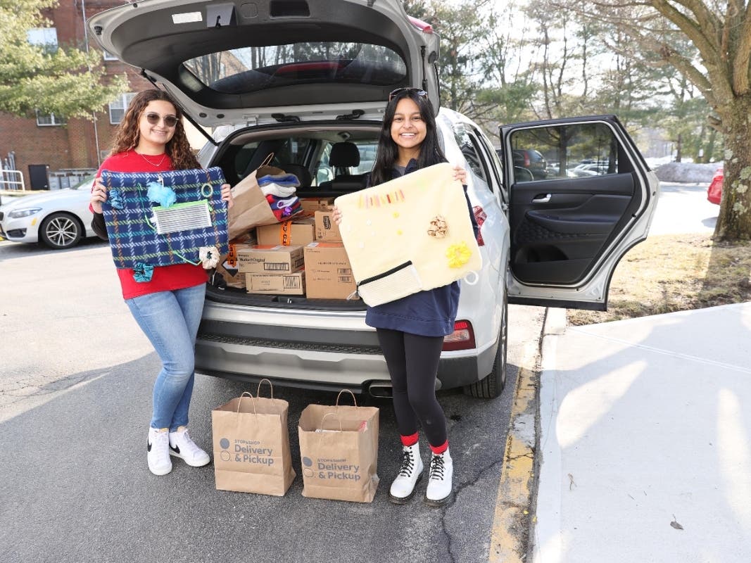 FCCLA Co-Presidents Alexandra Shepherd (left) and Trisha Kanhai display
fidget blankets as they prepare to unload donated items.