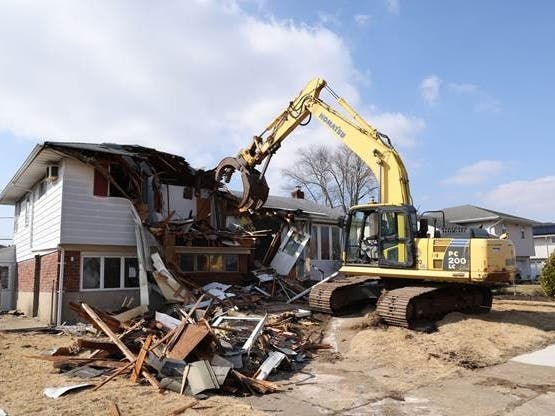 A "zombie home" in Farmingdale was demolished on Wednesday by the Town of Oyster Bay.