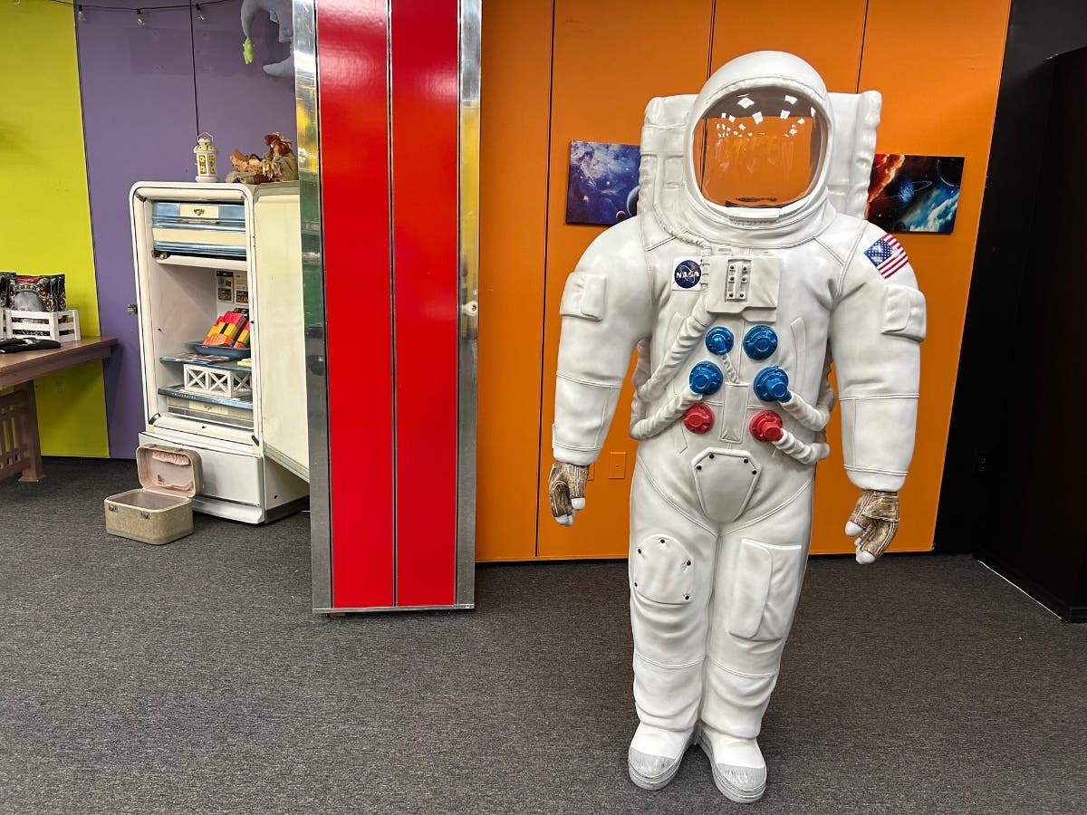 Astronaut Steve, a figure people can pose behind for photo opportunities, stands in Buster Moon in Farmingdale. The shop is owned by MC Martin, who will have help from her daughter, Molly.