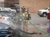 Centereach firefighters battle a car fire near Smith Haven Mall in Lake Grove on Sunday.
