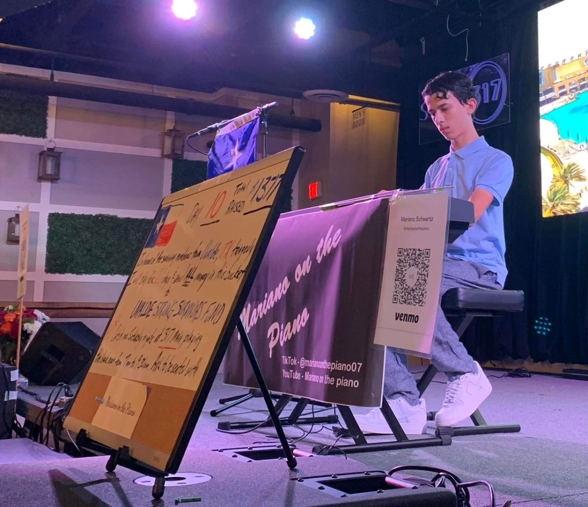 Marino Schwartz, 16, of Farmingdale, plays the piano at 317 Main Street. Schwartz donates his tips to charity, including $10,000 for the Bronx Veterans Medical Research ReWalk program.