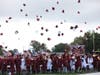 The graduates of the Walt Whitman class of 2023 toss their caps high.