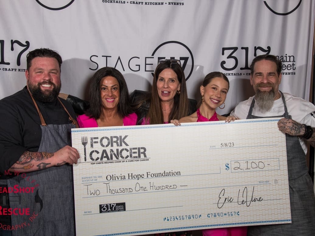 Chef Eric LeVine (right) presents a check to the Olivia Hope Foundation at a previous event. A Taste of TV event to benefit the Olivia Hope Foundation is scheduled for Sept. 25 at 317 Main Street in Farmingdale.