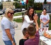 New Smithtown Elementary School Principal Dr. Mary-Ellen Kakalos high fives an incoming student.