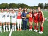 Pat Corey with members of the Smithtown High School East and High School West field hockey teams.