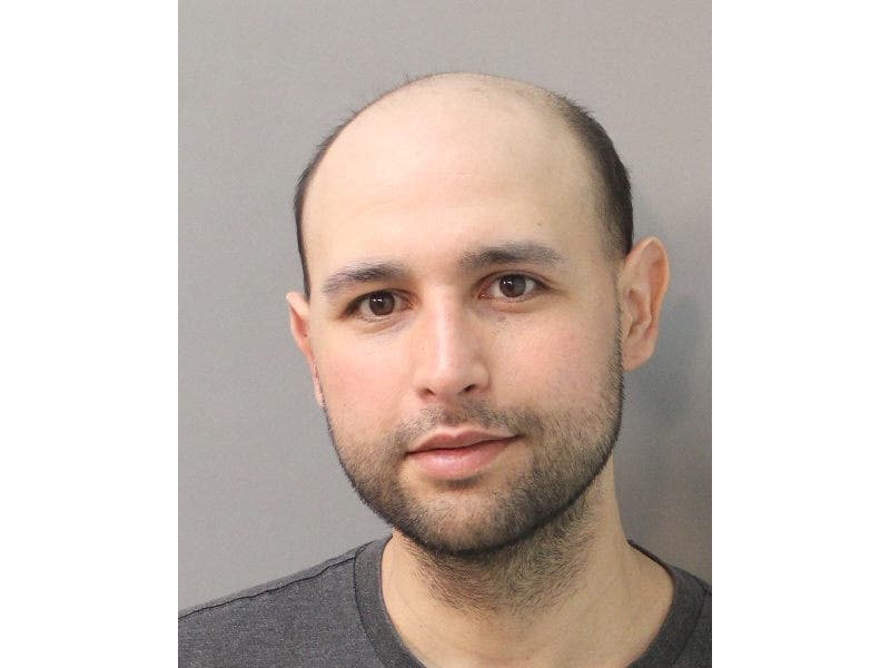 Mitchell Robi, 32, of Queens, pretended to be an undercover police officer and frisked a man in Elmont on March 17, Nassau police said.