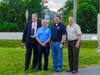 Mark Deeds, President Craig Harman,  Asst. Chief Chuck Tucker and Vice President Wylie Donaldson stand at the flag pole.
