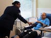 Air Force Tech Sgt. Akesha Lowry of Crofton presents a certificate of appreciation during an Honor Salute for Hoyt Gamble, a patient at Futurecare Landover.