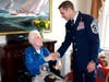 Dennis Lorentz receives a handshake from Air Force Chief Master Sgt. Jake Higginbotham during an Honor Salute held performed for veterans at Atria Manresa in Annapolis. Hospice of the Chesapeake is always in need of volunteers like Higginbotham.