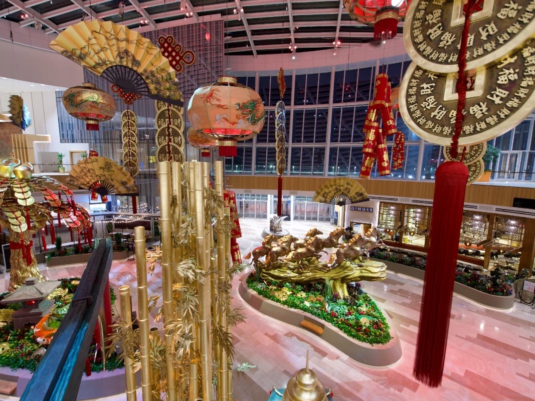 The Conservatory's Lunar New Year display includes eight galloping horses stretching across 32 feet, a golden bamboo forest reaching 25 feet in height, a money tree adorned with oversized gold I-Ching coins and iglots, and more.