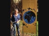 Artist Laurie Bogdan photographed with collaborative  door with Artlinks Arlington artist Jason Rudokas