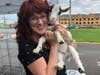 Debbie Huster, of Debbie's Mane Concern, organizer of the fundraiser, is enjoying one of the pygmy goats.