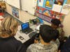 Cadets using the flight simulator are guided by a CAP Pilot.