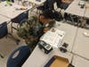 A senior member reviews instructions for the calculator robot