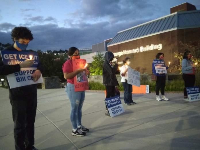 Supporters of a bill to end Howard County's contract with ICE in front of the George Howard building in Ellicott City Monday night.