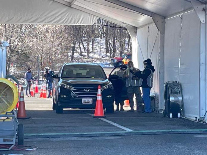 Kerri Shepet, a Howard County elementary school teacher, receives a COVID-19 vaccine Friday on the first day of a state mass vaccination site at Six Flags Great America in Prince George's County. Photo by Bruce DePuyt.