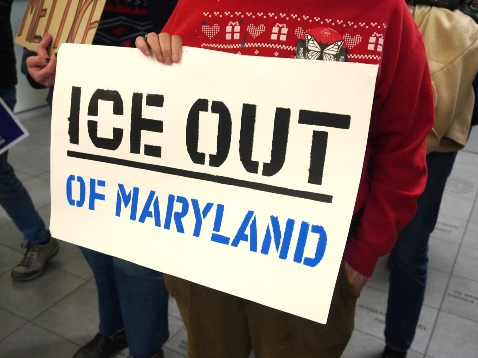 A sign held Nov. 14 during a press conference at CASA Welcome Center in Baltimore.