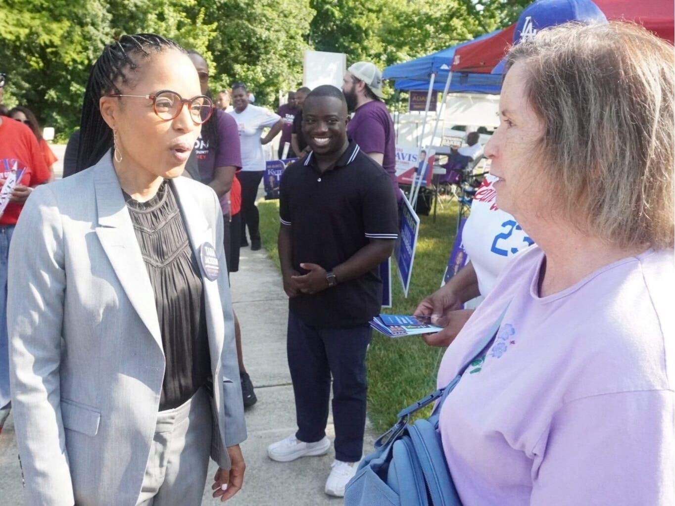 Sen. Angela Alsobrooks (D-Md.) chats with Patty McGuire outside Bowie City Gymnasium on the first of early primary voting in Maryland on Thursday.
