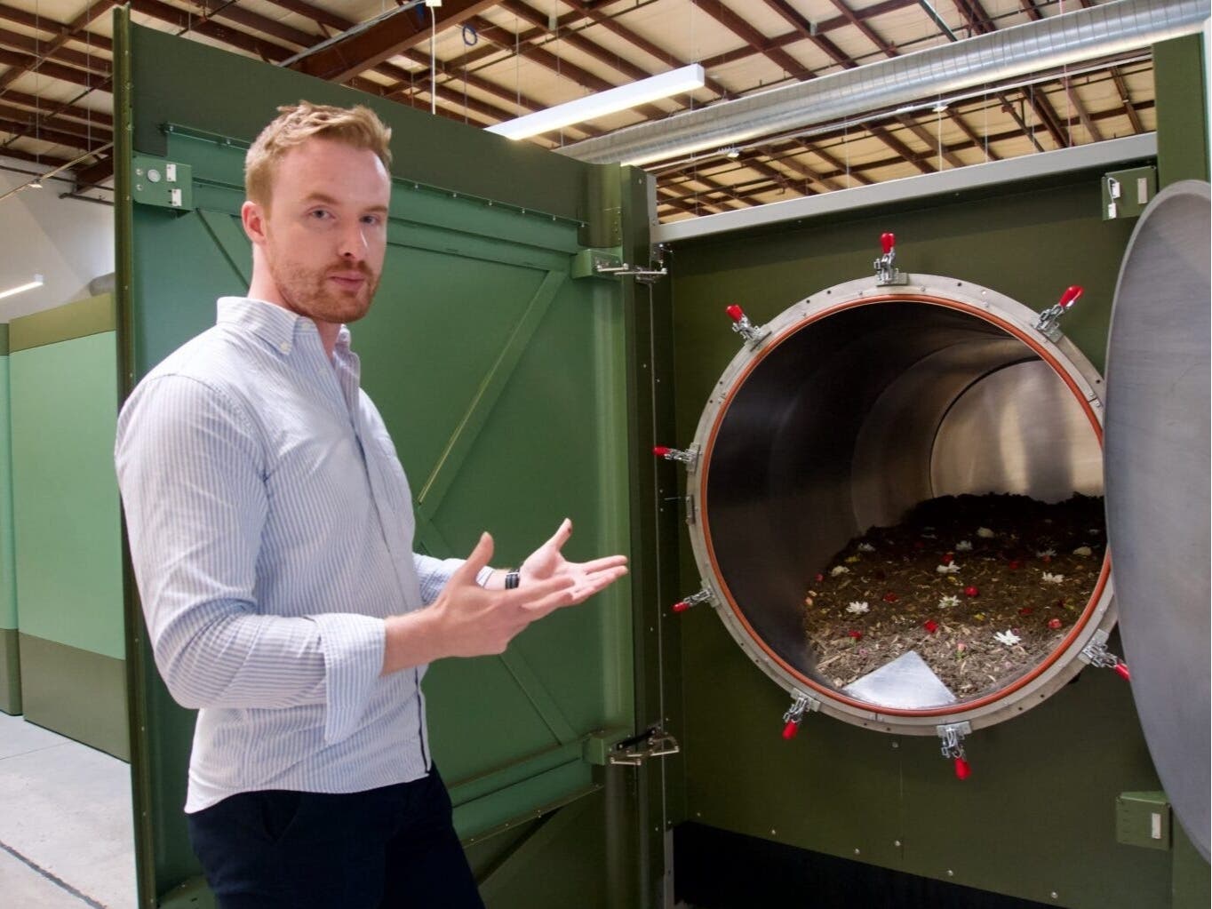 Earth Funeral CEO Tom Harries displays a natural organic reduction vessel, full of mulch, wood chips, flowers and other natural materials.