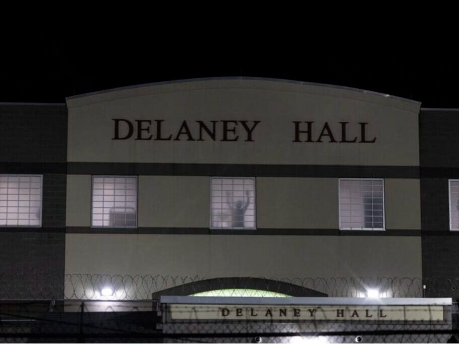 A detainee stands silhouetted in a window of the Delaney Hall detention center in Newark, N.J., on May 28, 2026. Many federal judges are freeing immigrants held under a mandatory detention policy.