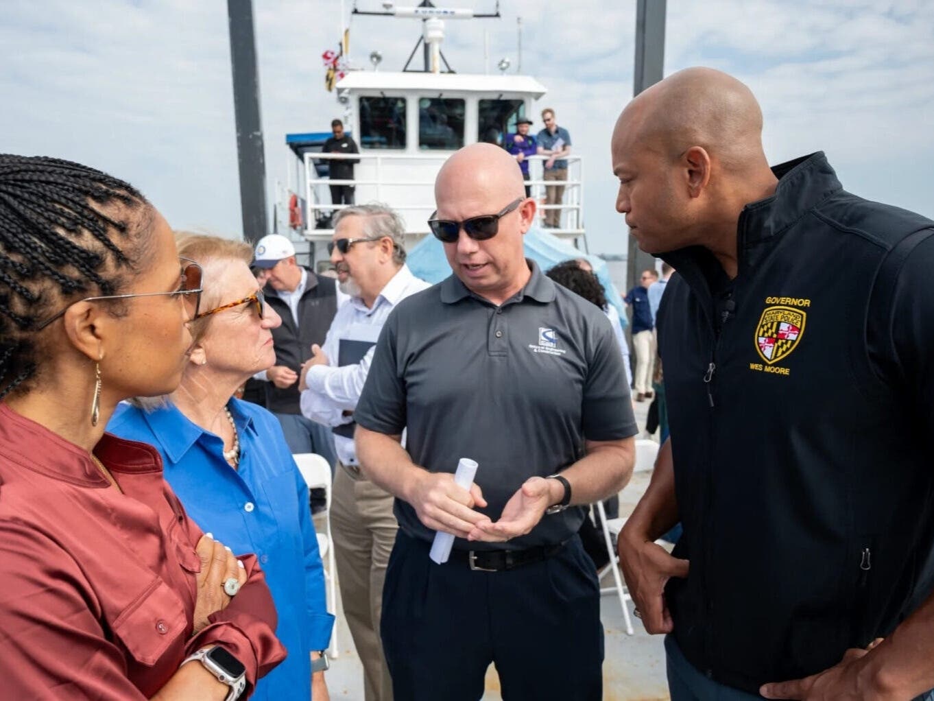 From left, Sen. Angela Alsobrooks (D-Md.), Sen. Shelley Moore Capito (R-W.Va.) Maryland Transportation Authority Chief Engineer Jim Harkness and Gov. Wes Moore (D) tour the Key Bridge site. 