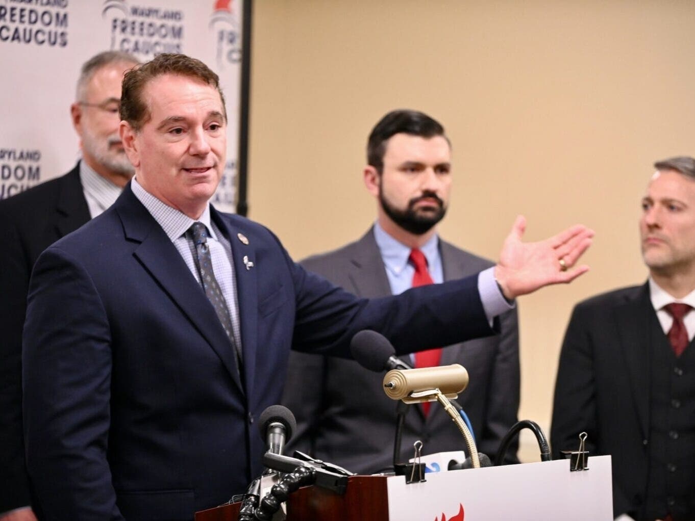 All seven members of the Maryland Freedom Caucus signed onto a lawsuit challenging Maryland's redistricting ballot question, including chair Del. Matt Morgan (R-St. Mary's), shown here at a February event with U.S. Rep. Andy Harris (R-1st) behind him.
