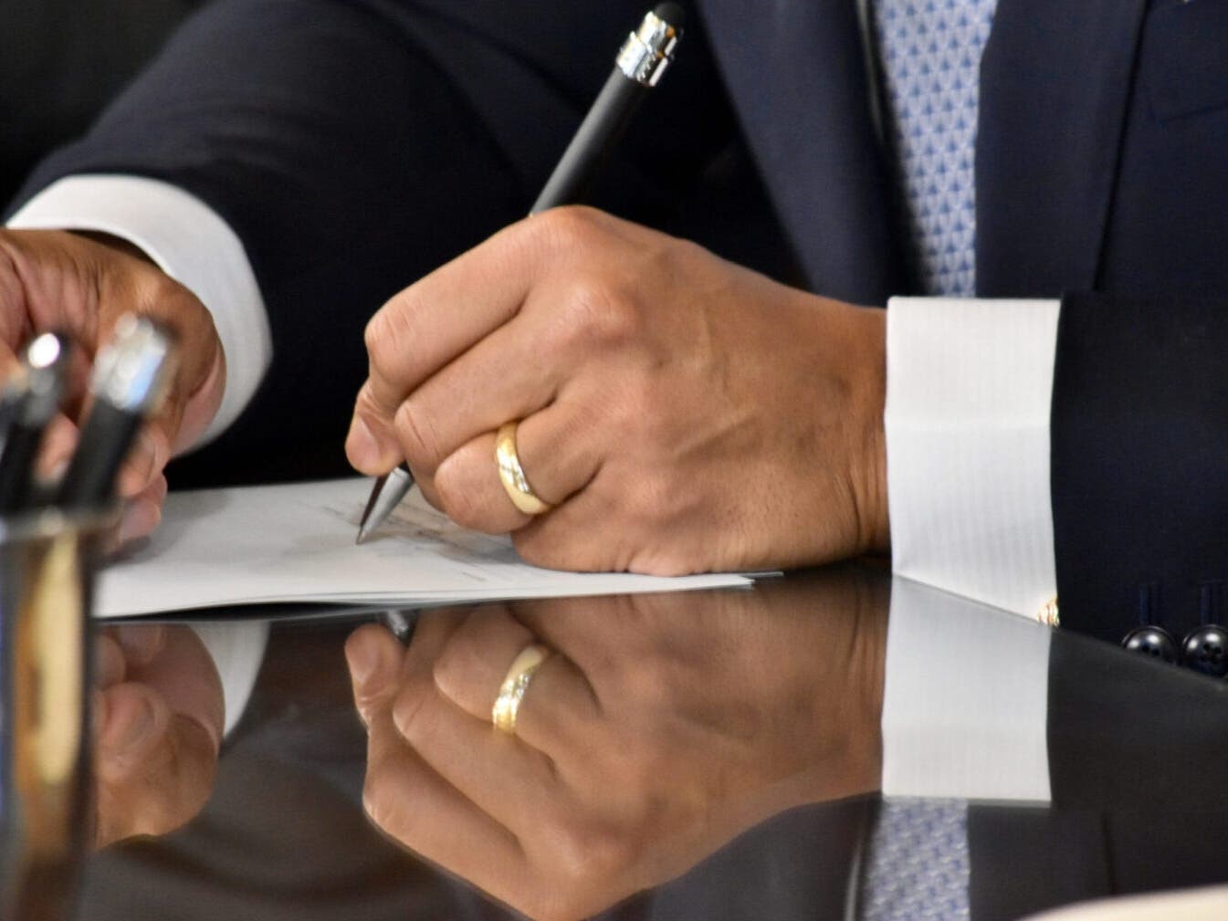 Gov. Wes Moore signs legislation into law in this file photo. The governor, who is ambidextrous, alternates between his right and left hands as hundreds of bills are signed.