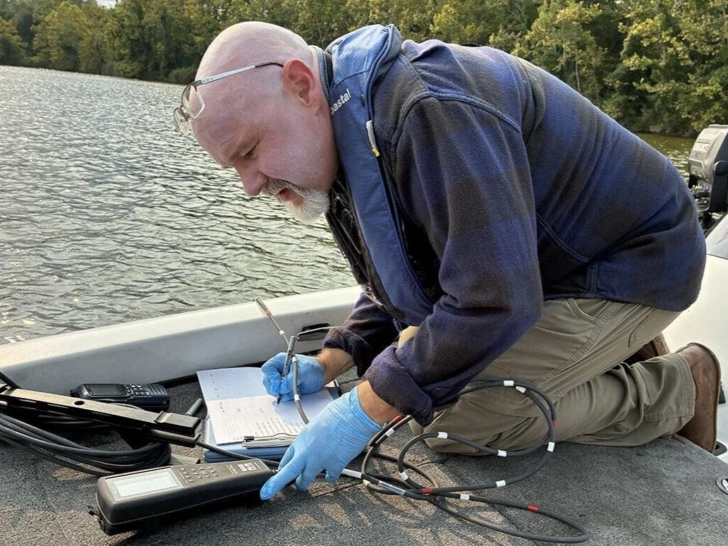 Riverkeeper Theaux Le Gardeur records water quality measurements for a pond off Days Cove along Maryland’s Gunpowder River.
