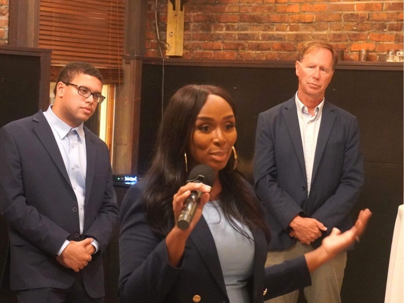 Sen. Shaneka Henson (D-Anne Arundel) gives remarks at a reception Thursday at Metropolitan Kitchen and Lounge in Annapolis. Anne Arundel County Executive Steuart Pittman (D), right, and Spencer Jones, a Democrat seeking a seat on County Council, listen.