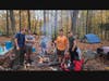 Troop 154 scouts cook a dutch oven dinner over an open fire with coals