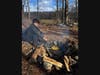 Scout cooking over an open fire