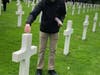 Herndon HS band students sprinkle dogwood petals on the gravesites of fallen soldiers from VA during D-Day invasion.