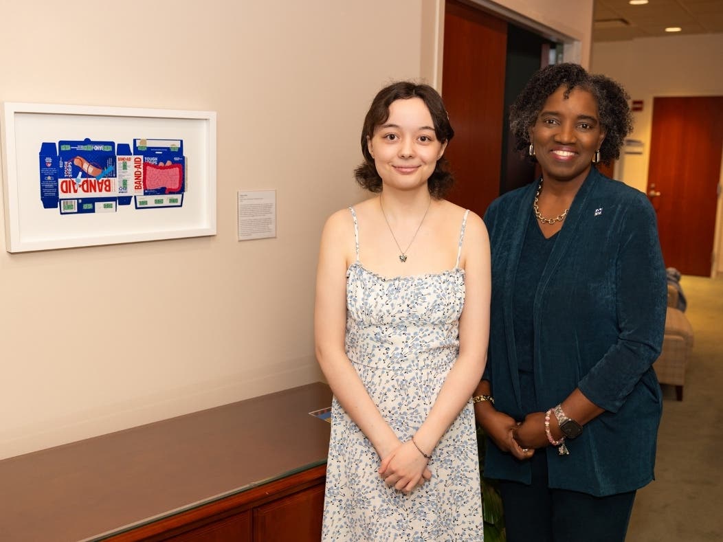 Becky Reck (left), a recent Harper College alumna, was one of two individuals who were honored with the 2026 President's Art Selection Award. Reck's work, "Crohn's," is now displayed in the office of Dr. Avis Proctor (right), Harper's president. 