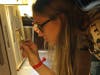 Young person examines manuscript from Glencairn Museum’s collection.