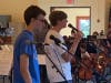 Teen singers accompanying the rock orchestras at the final rehearsal. 
