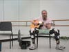 Theo Rooding plays guitar at the Veteran Civilian Arts Ensemble at the Straz.