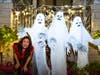 Kelly Fitzsimmons, owner of Light Up Your Holidays, with three ghostes.