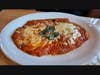 Pollo Parmigiana: Breaded & pan-fried chicken breast topped with tomato sauce, mozzarella, and parmesan cheese, served with truffle fries.